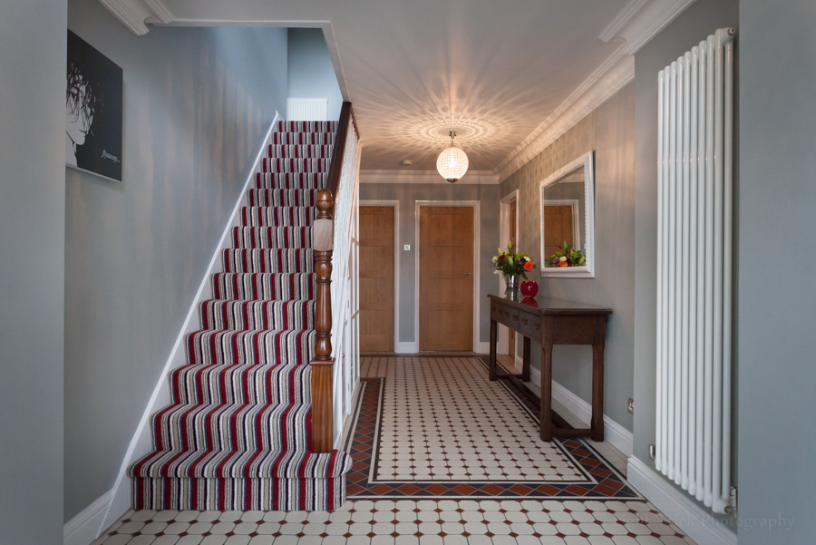 stylish hall with stripy staircase carpet